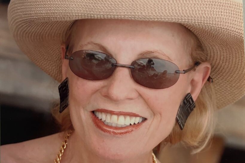 Suzanne Binswanger in a straw hat and sunglasses